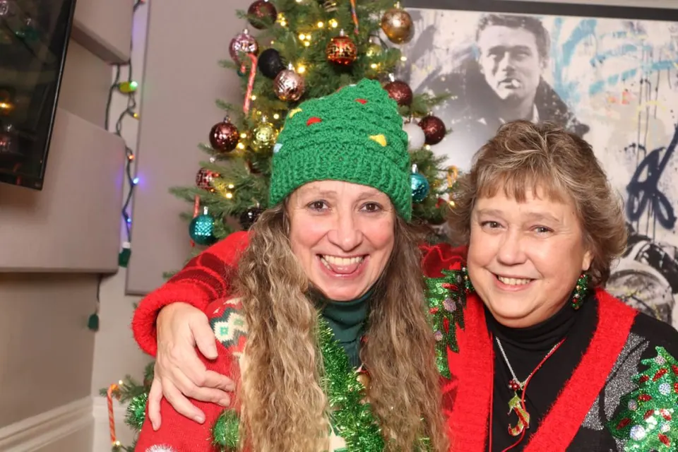 Friends in red and green Christmas outfits at a past bar crawl